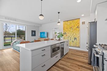 a kitchen with a white counter top and a refrigerator